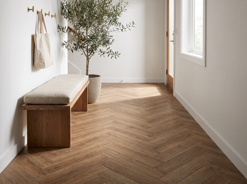 Herringbone wood-look porcelain floor tile in a modern entryway