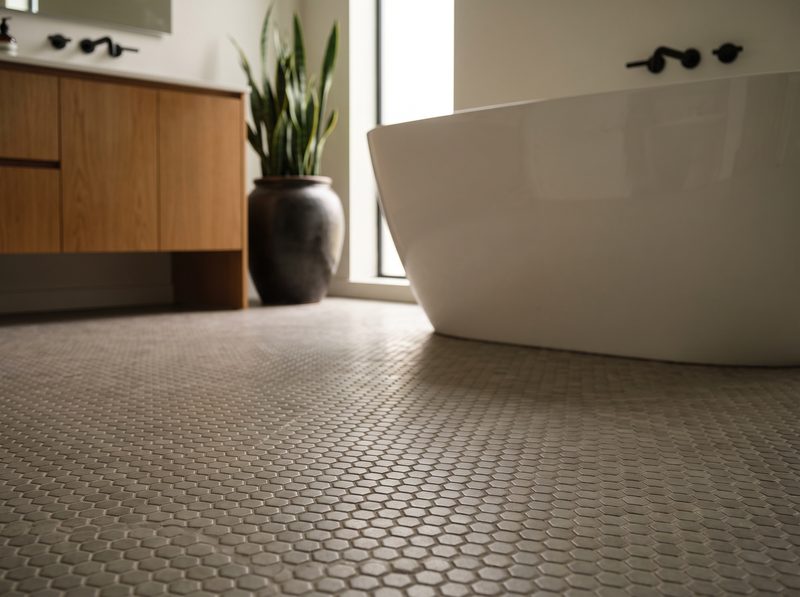 Warm gray hexagon mosaic floor tile in a spa-like bathroom