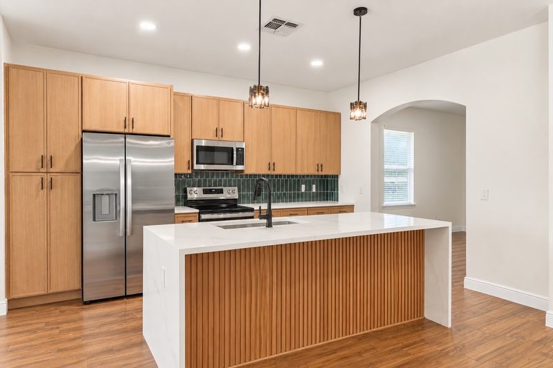 Kissimmee kitchen after: new cabinets, waterfall island and tile