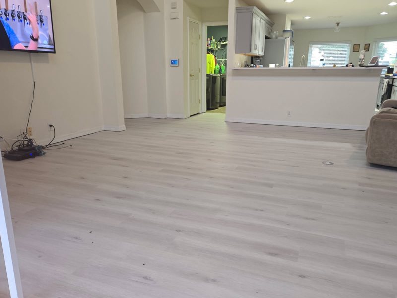 Living room at floor level after, with White Haven LVP running to the kitchen