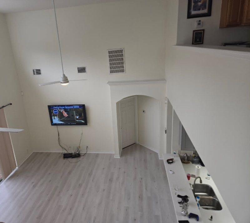 Same living room from the loft after, with light gray White Haven LVP