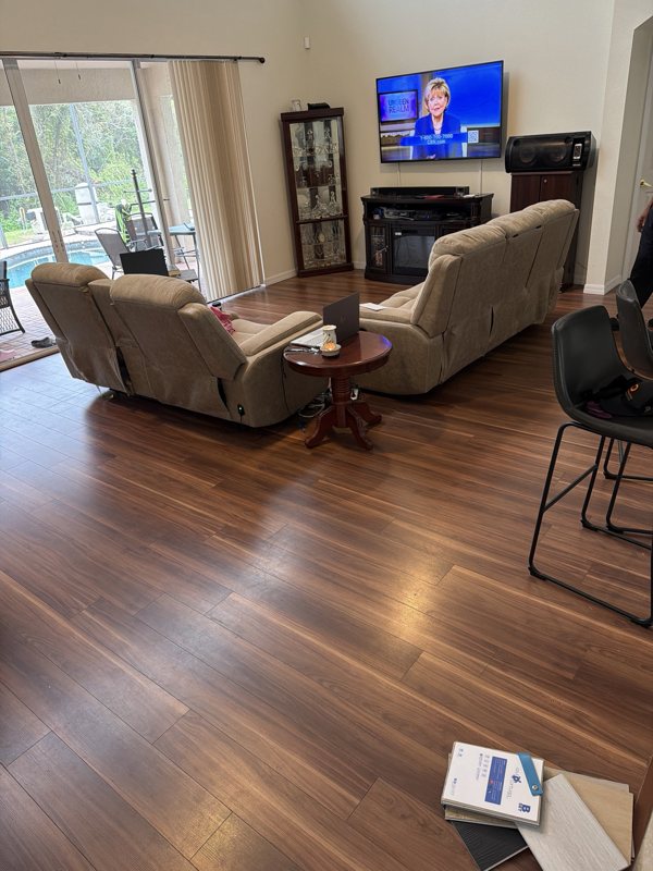 Living room at floor level before, with dark laminate